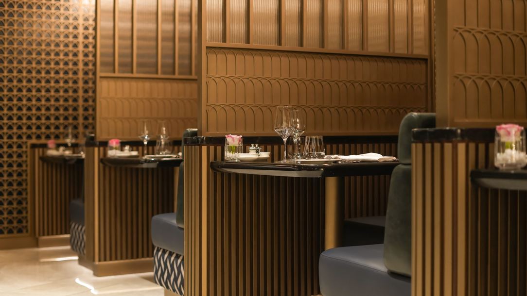 Tables set for dinning at the A detail including a grand chandelier at the British Airways lounge at Dubai airport..