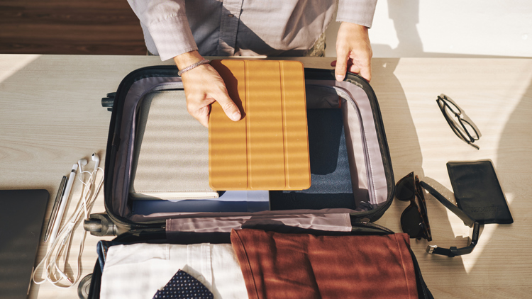 A man packing a suitcase.