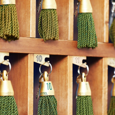 A close up of hotel keys with green tassels.
