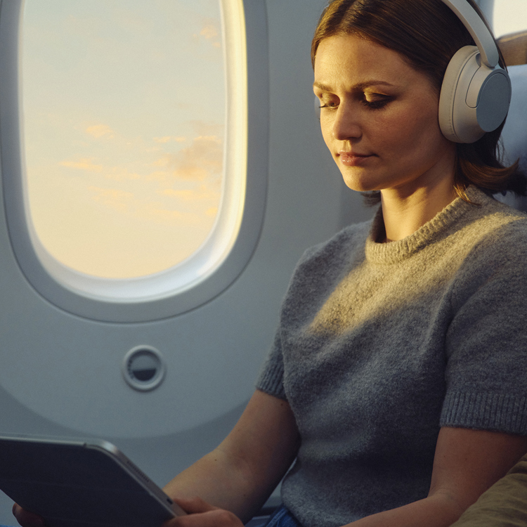 A lady enjoying the inflight entertainment on a British Airways plane.