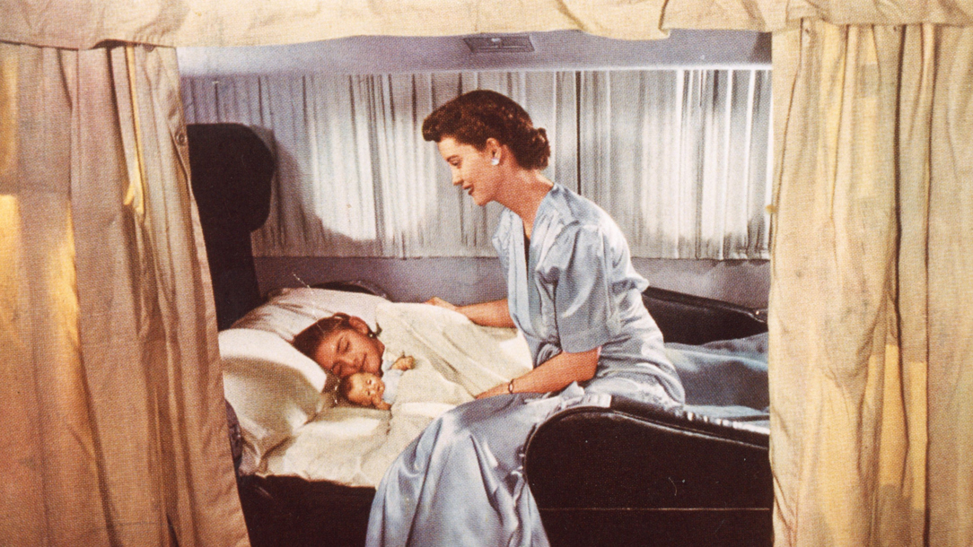 A young girl with her mother asleep on a BOAC Boeing Stratocruiser.