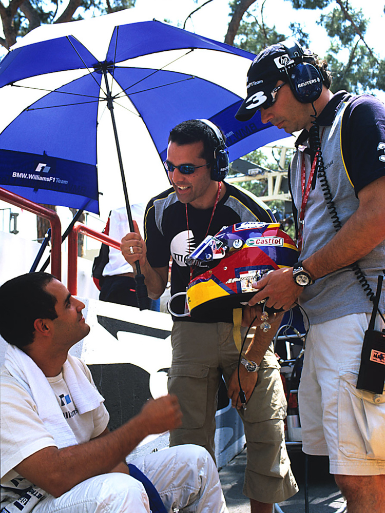 Julian Keel working with Juan Pablo Montoya at an F1 race.