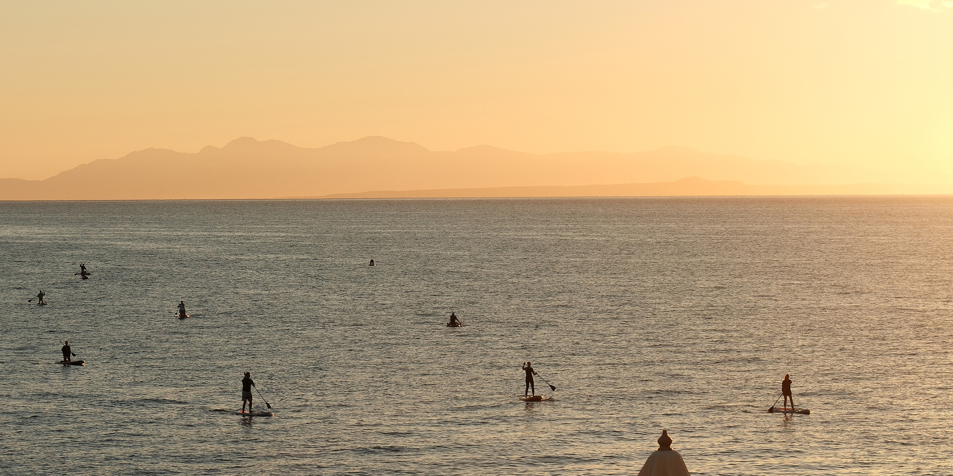 Paddle boarding at sunset at the Peligoni Club.