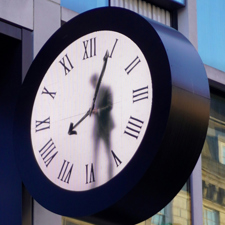 A clock with a figure on a person in the dial.