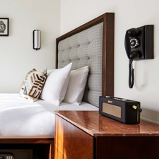 A room with a radio next to the bed at the Hoxton Portland hotel.
