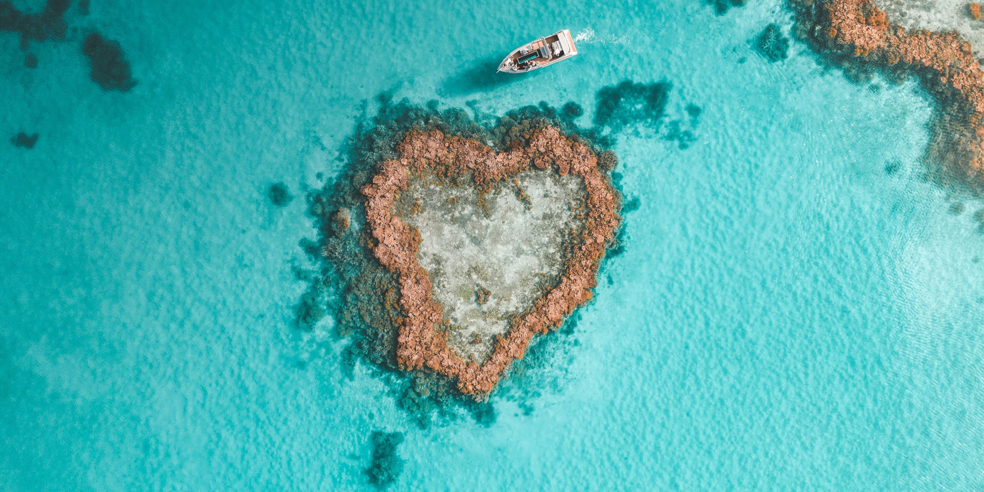 Aerial view of a tiny island in the Great Barrier Reef.
