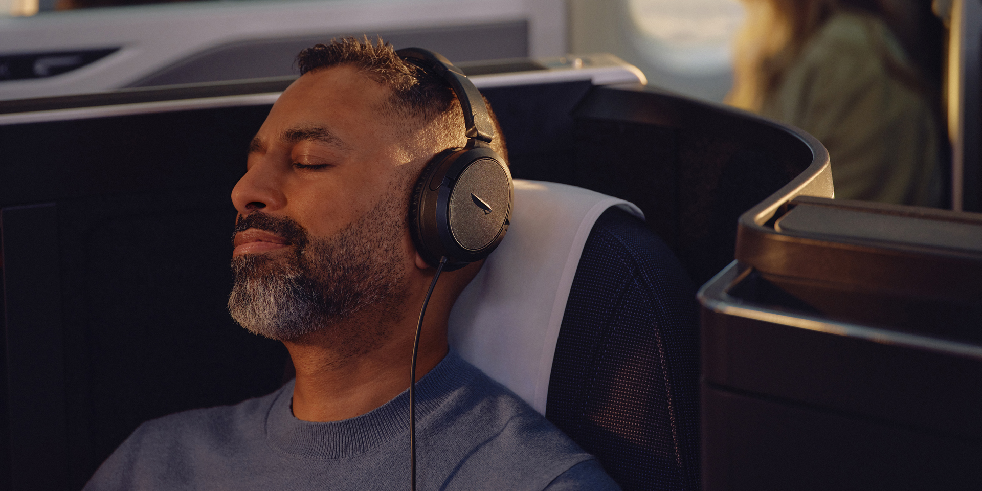 A passenger relaxing on a British Airways airplane.