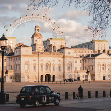 Horse Guards building with a cab driving past.